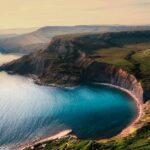 An image of one of the best beaches in England, showcasing the natural limestone arch.