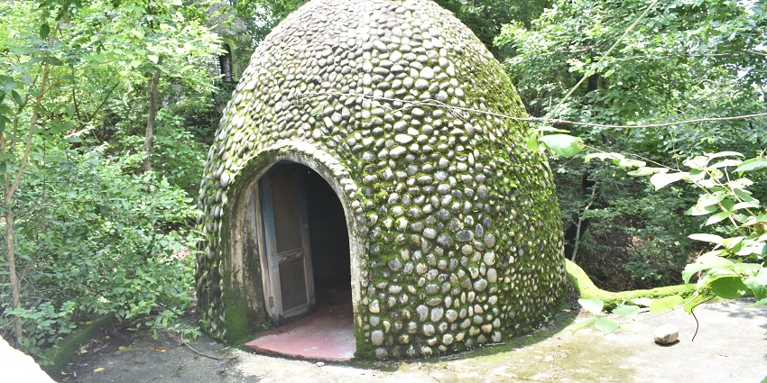 Cave at the historic ashram visited by The Beatles, now a serene retreat.