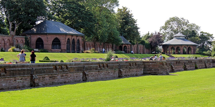 The Terrace area of Stanley Park features a carpet of grass and a few ancient buildings.