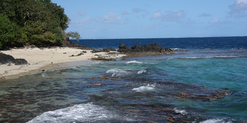 A view of the beach meeting ocean water - one of the best places to visit in Fiji