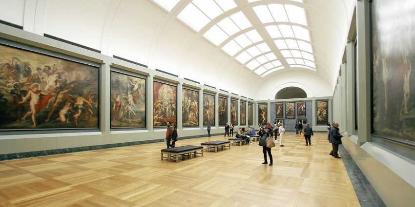 An image showing an exhibit with a stunning painting display in a well-lit museum gallery.