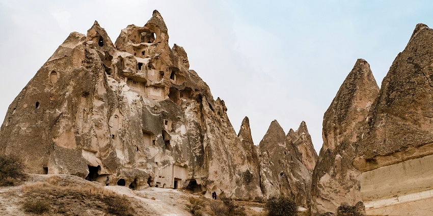 Aerial view of the various caves under clear blue sky and broken stones surrounded