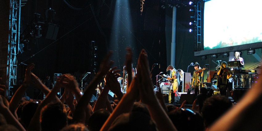 Osheaga Music Festival captured with stage lights illuminating the band and audience.