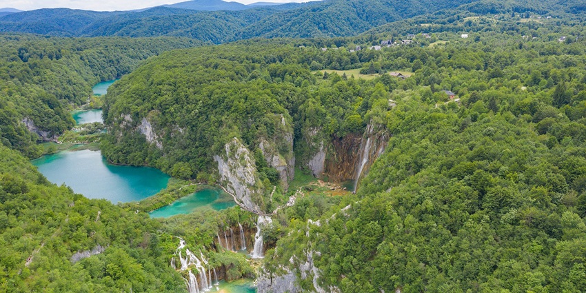 An aerial view of the Plitvice Waterfalls capturing the park's beauty during spring.