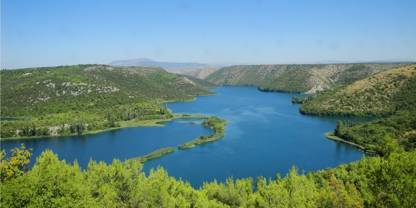 A view signboard showing Krka National Park timing during the spring season.