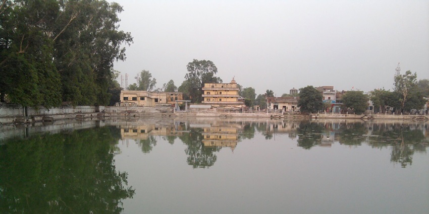 Hariharnath Mandir of Gyanpur reflected across serene temple tank at Gyan Sarovar.