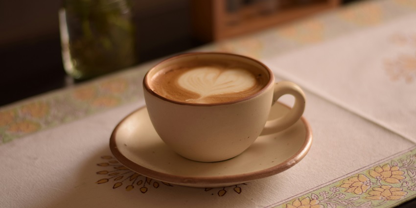 Image of a coffee shop, serving coffee on a table with beautiful decorations
