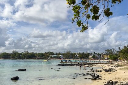 The picture of Blue Bay beach in Mauritius where people are enjoying their quality time.