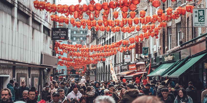 An Image of people walking and enjoying street shopping in London in the day.