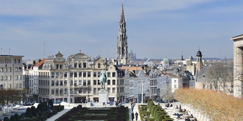 Grand Place in Brussels with ornate guildhalls, cobbled streets, and lively city atmosphere.