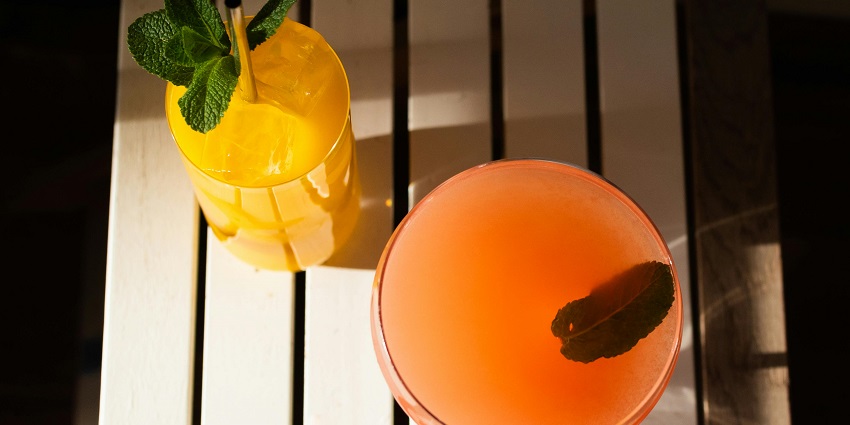 An image showing assorted bottles neatly arranged inside a bar, creating a vibrant display.