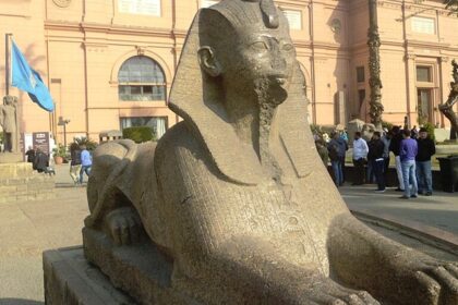 The statue in front of the entrance to the Museum of Antiquities in Cairo is located in Egypt.