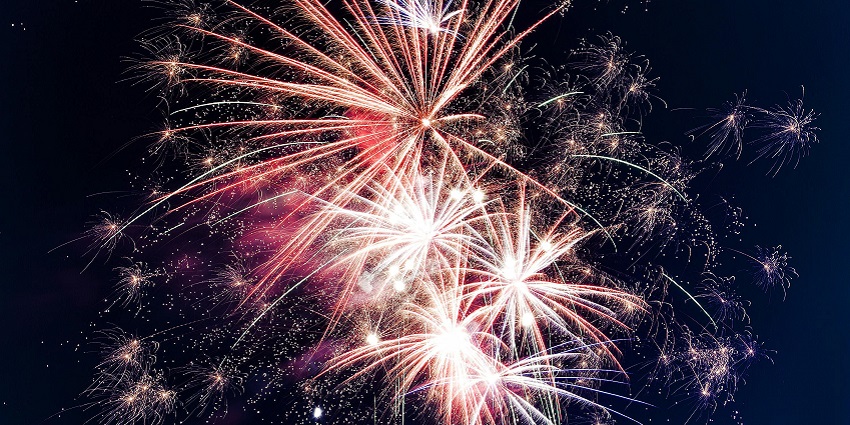The image shows colourful fireworks bursting in the night sky near Cape Cod