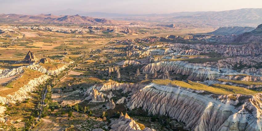The Turkey travel guide highlights a unique landscape with fairy chimneys and distinctive rock formations.