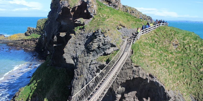 An Image of the Carrick-a-Rede Rope Bridge, a thrilling tourist spot in Northern Ireland.