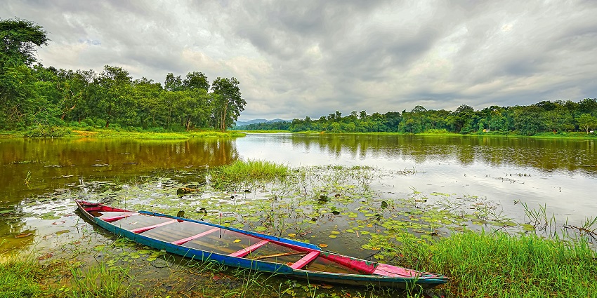 A woman enjoying boating at Chandubi Lake, one of the best picnic spots near Guwahati.