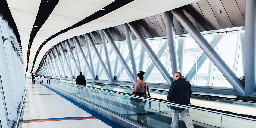 A view of a passenger walking through the airport terminal for their travel trip.