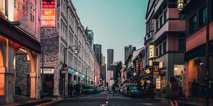 People throng a market at night in Chinatown, a place to visit on the Singapore travel guide.