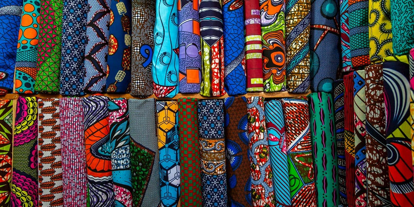 Image of a shop selling assorted-colorful textiles looking so vibrant in different designs