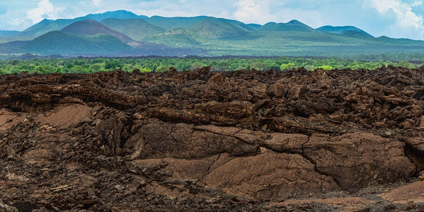 Shetani lava flow on the grounds of the national park with Chyulu hills in view