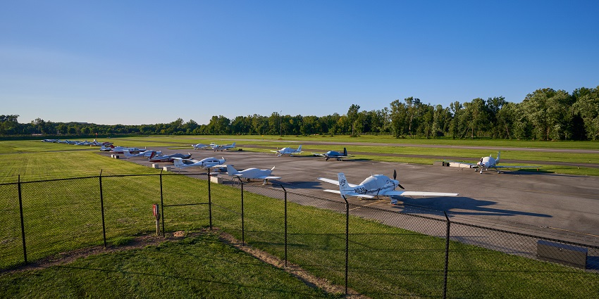 A vibrant view of College Park Airport building and runway under a clear blue sky in Maryland
