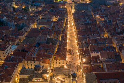 An aerial view of city buildings during the nighttime showcasing Croatia nightlife.