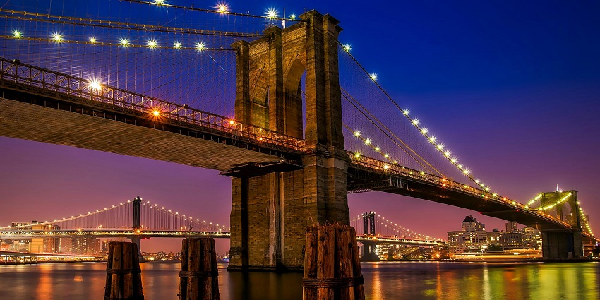 Brooklyn Bridge with unique architecture and vibrant and colourful lights on the bridge.