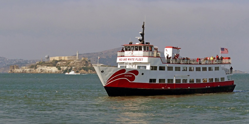 An image of A San Francisco Bay cruise with boats, water, and the city skyline in the background