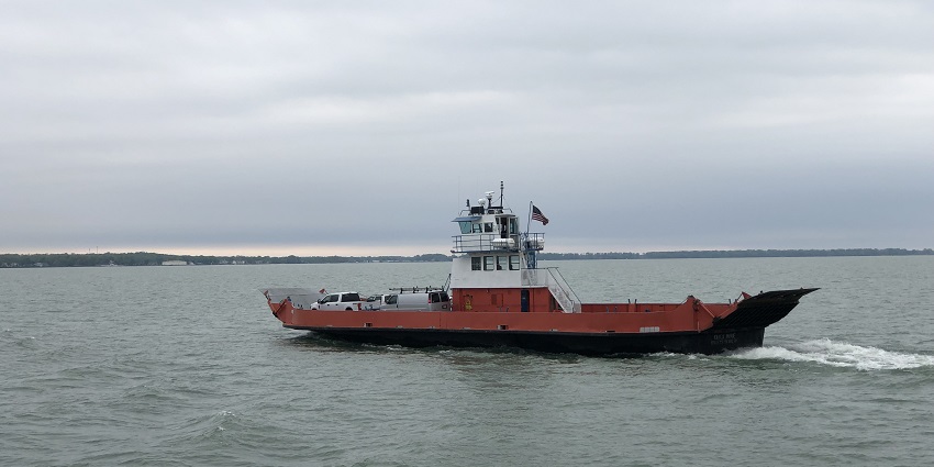 Lake Erie with a red and white ferry on the lake and the coastline visible at a distance