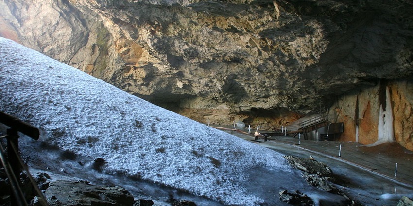 An image of ice stalactites and sculptures inside Dachstein Ice Cave, with mountain views.
