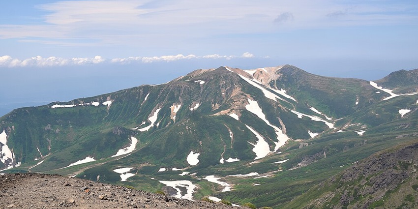Breathtaking view of Mount Asahi from Daisetsuzan National Park summit.