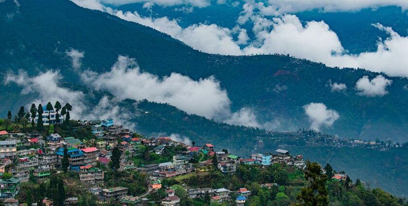 A wide view of Darjeeling shows a massive Kanchenjunga mountain in the background.