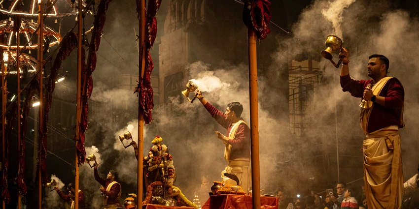Beautiful view of a group of men standing on top of a stage in Dashashwamedh Ghat