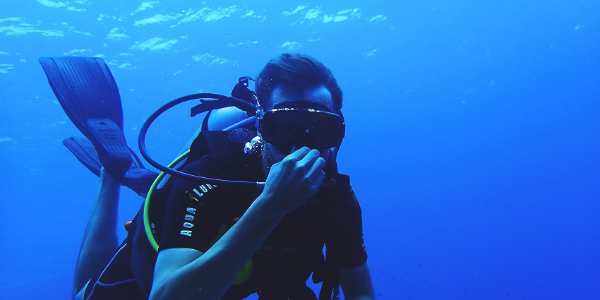 Scuba diving in Oman islands with exquisite coral reefs and abundant wildlife.