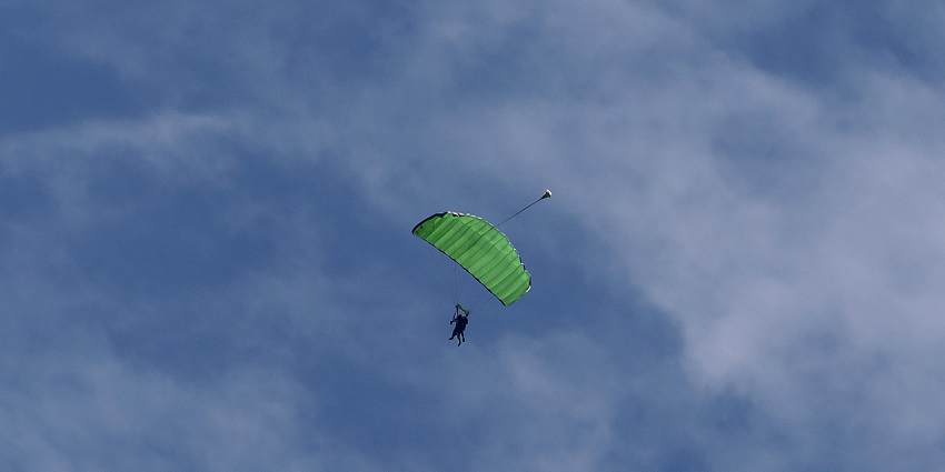 A picture of a skydiving, where a first-time jumper is securely connected to an instructor.