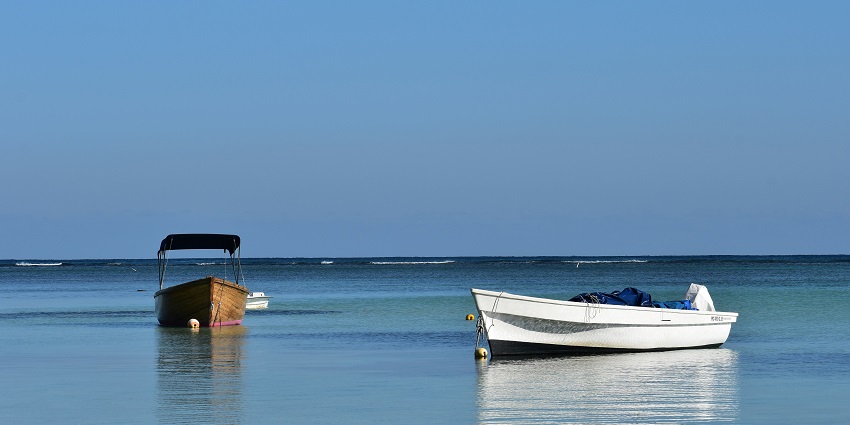 A middle-aged man is throwing his fishing rod, one of the best things in Mauritius.