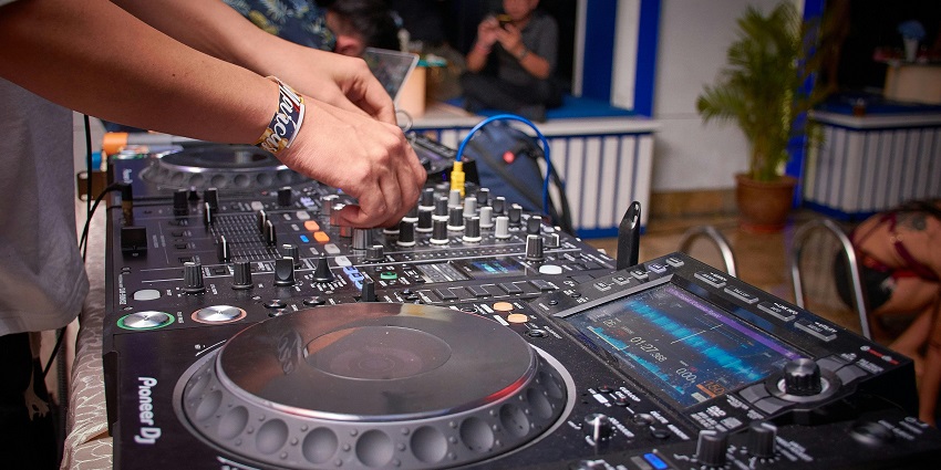 An image showing a chic DJ controller in the club.