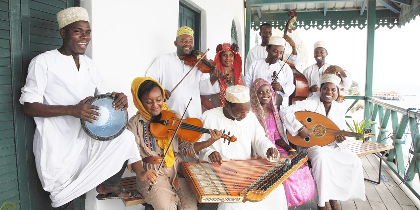 Members of Dhow Countries Music Academy performing with different kinds of instruments