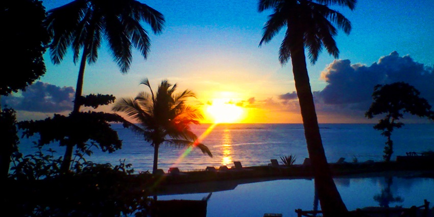 A mesmerising view of sunrise featuring a dark blue sky on Diani Beach in Kenya