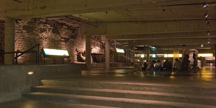 Pointe-à-Callière Museum with a group of people sitting in the middle of the museum