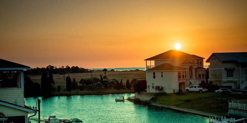Sunsets on the horizon in the background of a house in Tampa Bay, Florida, United States.