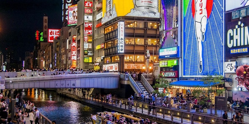 Vibrant nightlife district with neon signs and street food