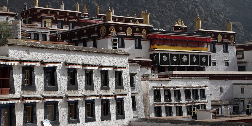 Multiple windows and intricate architecture of the Drepung Monastery.