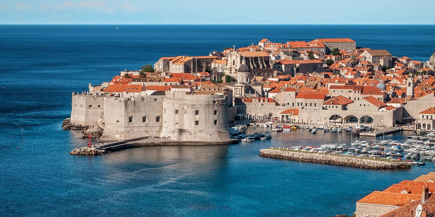 An image view of Dubrovnik's Old Town with its city walls overlooking the Adriatic Sea.