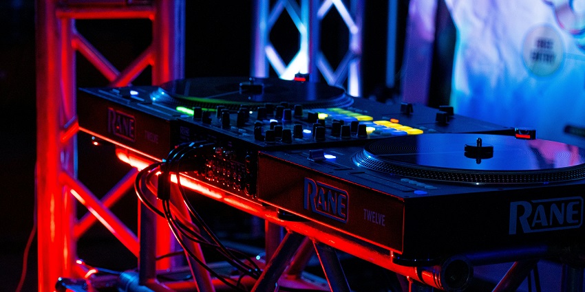 An image of a woman dancing energetically in a nightclub captures a disco party's lively essence.