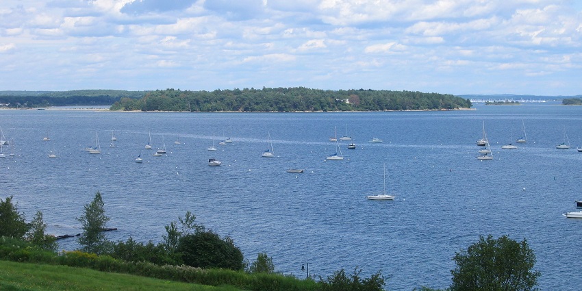 Scenic waterfront park with walking paths, lush greenery, and views of Casco Bay.
