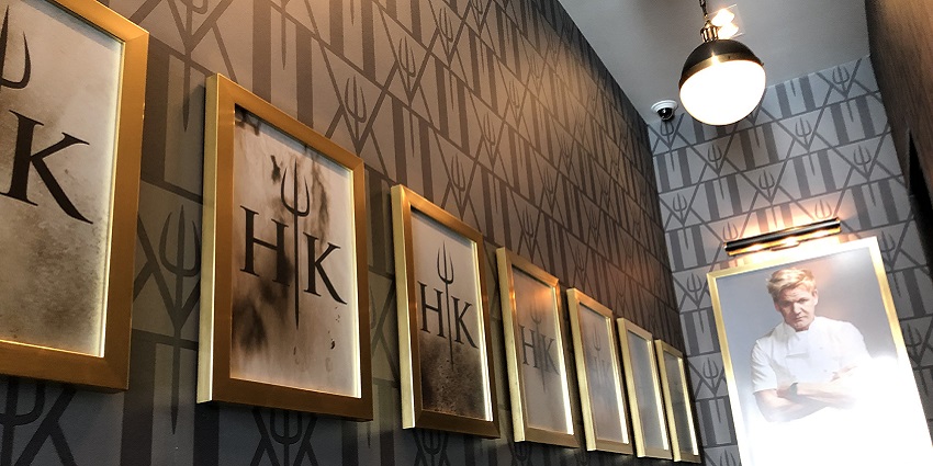 Inside Gordon Ramsay’s Hell’s Kitchen with framed photos and a portrait of Gordon Ramsay