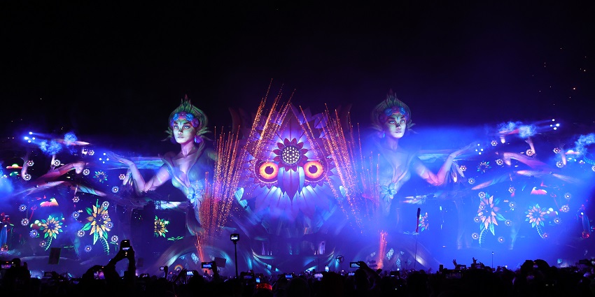 An image of the neon lights and crowds dancing at the Electric Daisy Carnival in Las Vegas