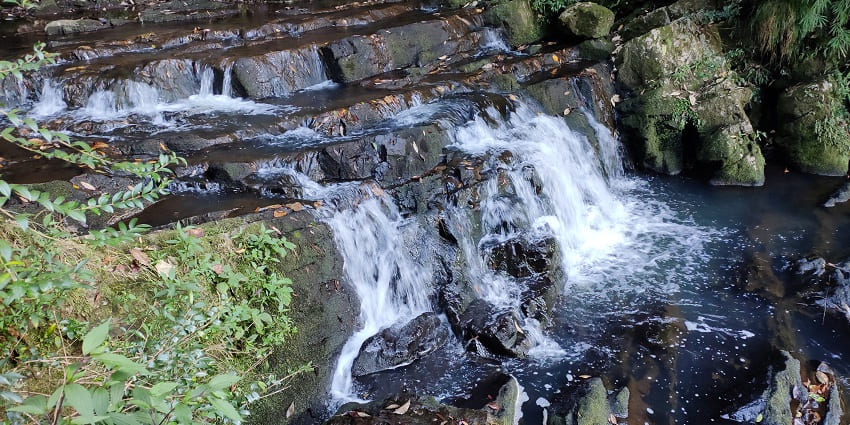Captivating multi-tiered waterfall amidst verdant greenery in Shillong, Meghalaya.
