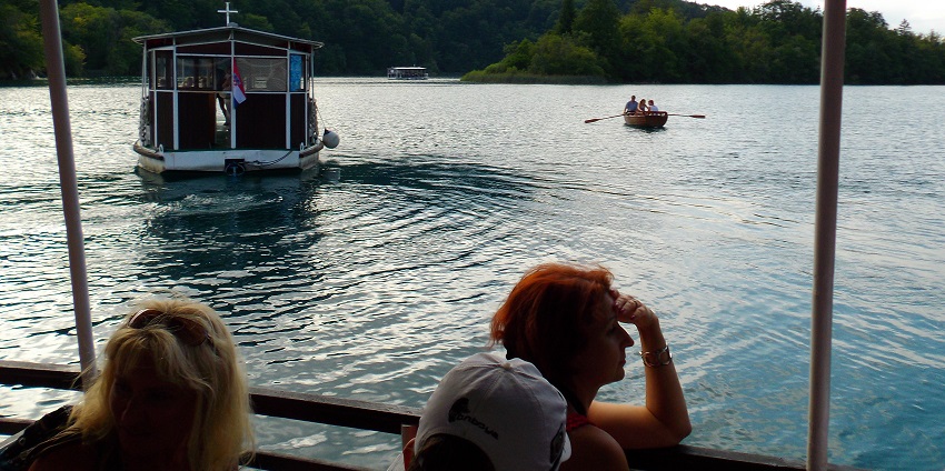 A picture of a boat riding through the serene waters of the national park in Croatia.